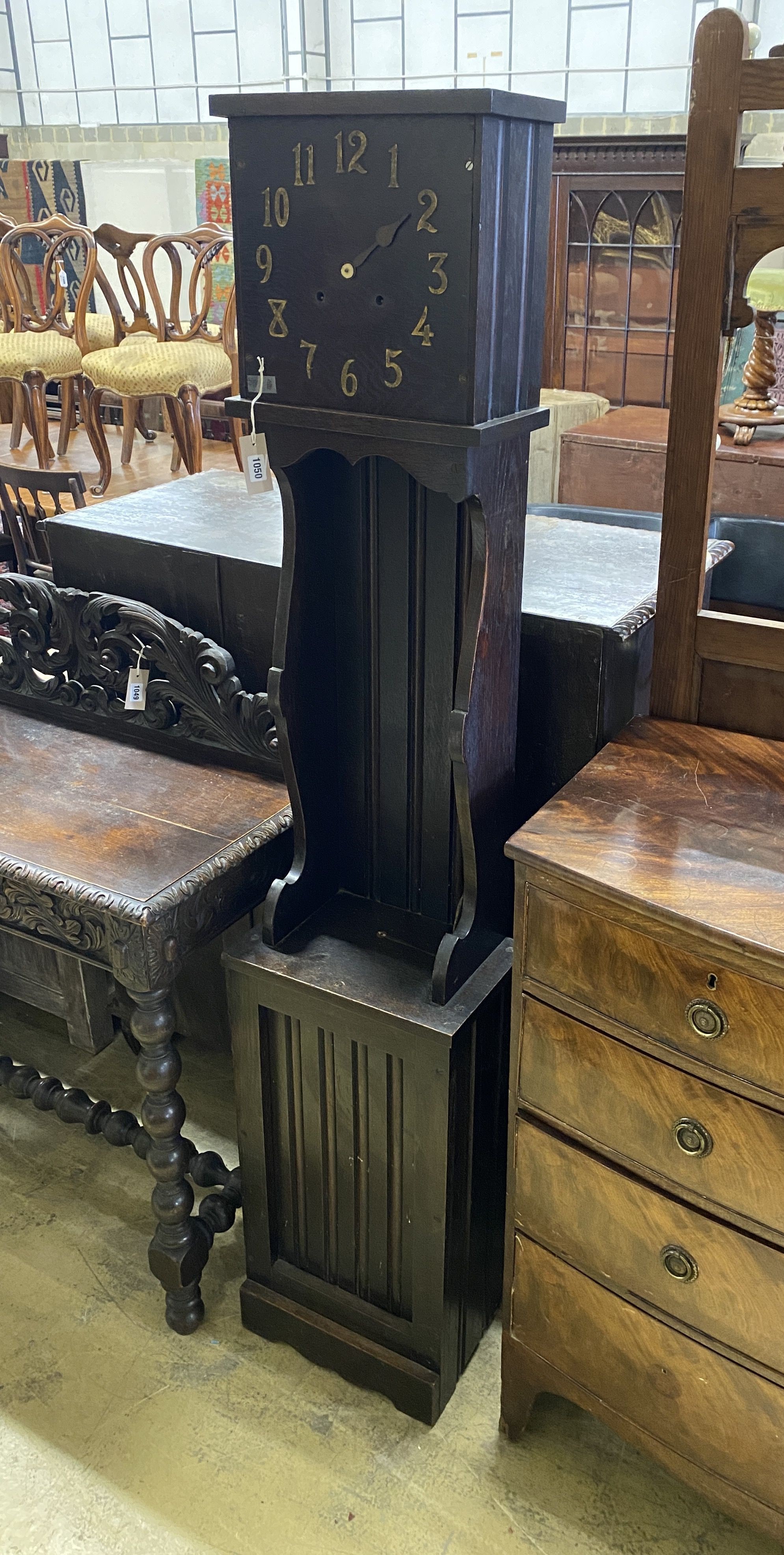 An 'Arts and Crafts' style oak longcase clock, height 184cm